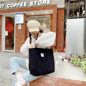 Sac cabas en toile noir pour femme, style littéraire minimaliste, sac épaule décontracté.