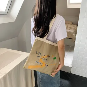 Casual canvas tote bag with inspiring letter print, large capacity daily shoulder bag.