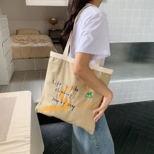 Casual large capacity canvas tote bag with stylish embroidery and comfortable shoulder straps.