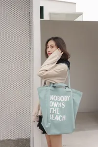 Canvas tote bag for women, large capacity shoulder handbag with stylish letter print design.