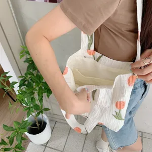 Detail view of white crinkle tote bag featuring sweet tulip print and handy interior pockets.