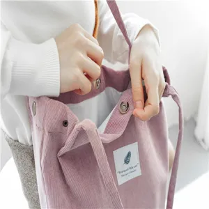 Pink corduroy tote bag detail showing interior snap button and label design for casual use.