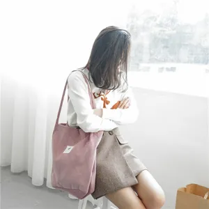 Stylish pink corduroy tote bag with large capacity, perfect for daily use and shopping.