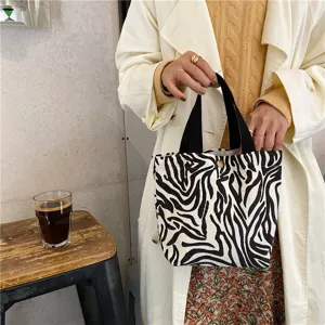 Zebra pattern corduroy lunch bag with black handles, casual daily handbag storage pouch.