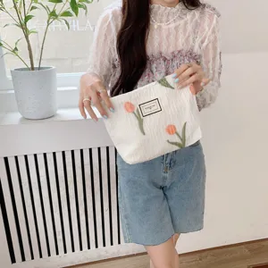 White quilted cosmetic bag with cute tulip embroidery, portable daily organizer pouch.
