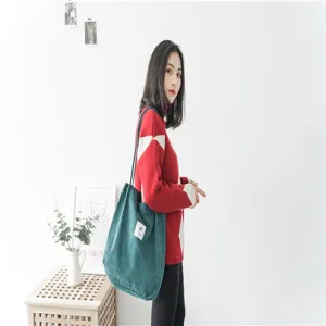 Green corduroy tote bag detail view, casual large capacity shoulder bag for everyday use.