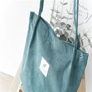 Green corduroy tote bag detail shot, large capacity casual shoulder bag for daily student use.