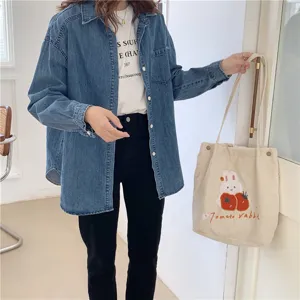 Details view of the cute corduroy shoulder bag with rabbit embroidery and tomato graphic.