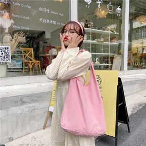 Pink canvas shoulder bag, casual hobo tote for women and students, perfect for daily street style.