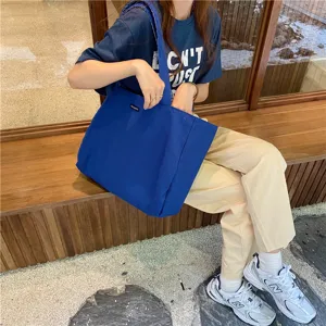Casual solid blue canvas tote bag for women, large capacity daily shoulder bag for students.