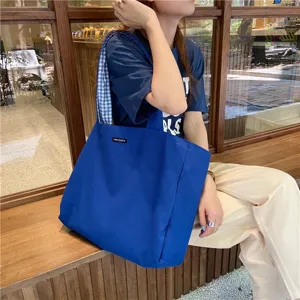 Casual canvas tote bag for women, large capacity blue shoulder bag with plaid lining.