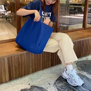 Casual blue canvas tote bag for women, stylish large capacity shoulder bag for use.