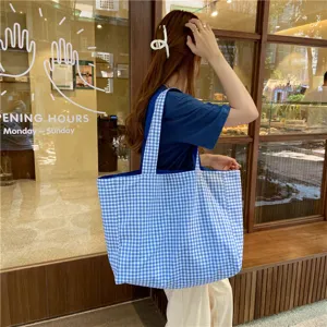 Detailed view of the casual blue and white plaid canvas tote bag, perfect for everyday use.