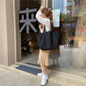 Casual black canvas tote bag for women, large capacity minimalist design for daily use.