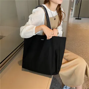 Minimalist canvas shoulder bag with plaid straps large capacity casual daily tote for students.