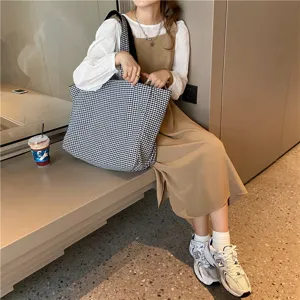 Detailed view of casual black and white plaid canvas tote bag for women daily commute use.