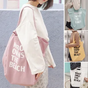 Korean casual large capacity canvas tote bag with letter print for women daily shopping.