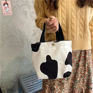 Cute cow print corduroy handbag for daily casual use, compact tote bag with sturdy handles.