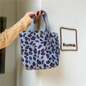 Blue grey leopard corduroy tote bag detail, featuring sturdy handles and metallic snap button.