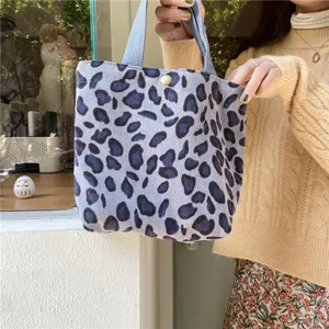 Close-up view of a stylish corduroy leopard print tote bag, showing soft texture and detail.