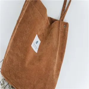 Brown corduroy tote bag with snap button, large capacity casual shoulder bag for women daily use.
