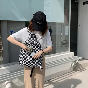 Sac à dos en toile à carreaux noir et blanc, cartable décontracté de grande capacité.