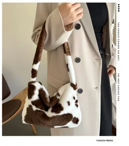 Plush shoulder bag for women, cute cow print underarm bag, soft fuzzy crossbody handbag.