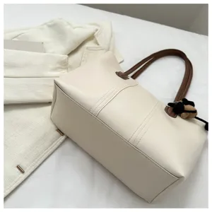 Korean style minimalist large tote bag with brown handles and cute bear charm detail.