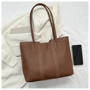 Brown leather tote bag with stylish contrast stitching, perfect for daily commuting and casual wear.