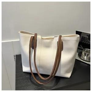 Chic white tote bag with brown straps, versatile casual shoulder bag for women daily commute.