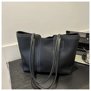 Black fashion women tote bag with contrast stitching, stylish PU leather shoulder bag.
