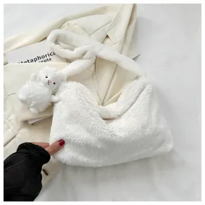 Fluffy plush shoulder bag for women, cute winter crossbody bag with small rabbit pendant.