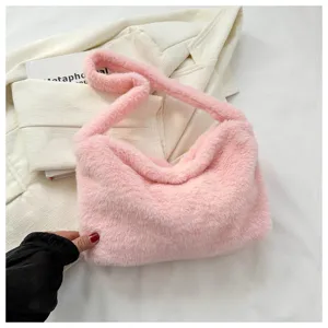Pink fluffy shoulder bag close-up, soft plush underarm handbag detail view for women.