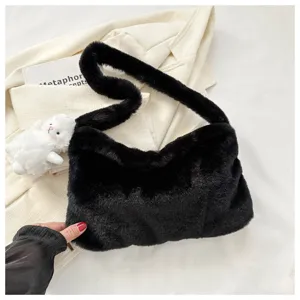 Black plush underarm shoulder bag detail, soft fluffy fabric texture and stylish design.