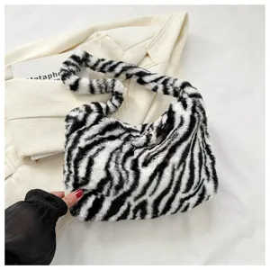 Zebra pattern plush shoulder bag detail showing soft fluffy texture and trendy design.