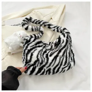 Detailed close-up view of the stylish black and white zebra pattern plush shoulder bag.