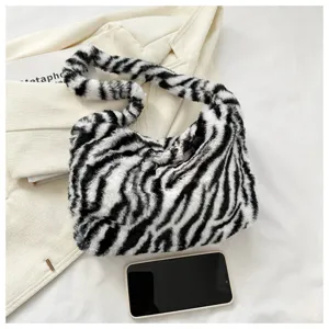 Detailed view of the black and white zebra print plush shoulder bag, showing soft texture.