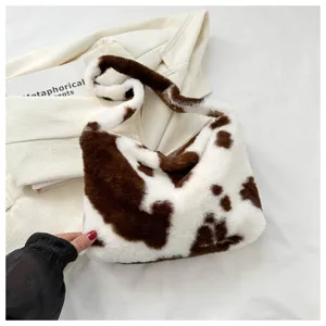 Plush cow print shoulder bag for women, cute fluffy underarm crossbody bag, trendy style.