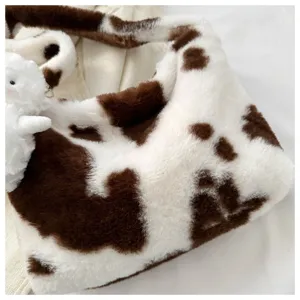 Soft plush underarm shoulder bag detail with cute brown cow print and bunny charm.