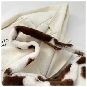 Plush cow print shoulder bag detail view, soft fluffy crossbody purse for women and girls.