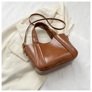 Brown soft leather tote shoulder bag for women, stylish bucket handbag with chic design details.