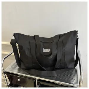 Large capacity black travel duffel bag, casual tote and shoulder bag for women daily use.