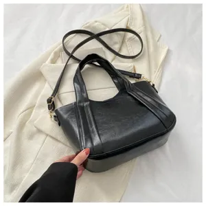 Black soft leather bucket handbag detail view, casual shoulder crossbody strap and handle design.