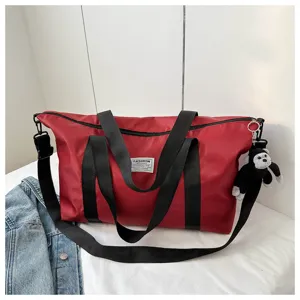 Large capacity travel duffel bag, casual tote handbag with shoulder strap and cute plush pendant.