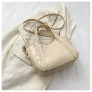 Beige PU leather bucket bag detail, stylish soft shoulder handbag for women daily wear.