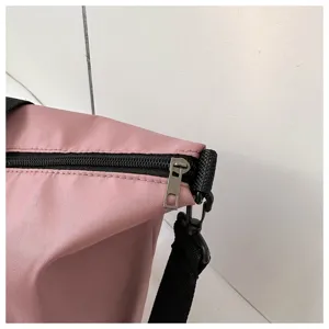 Pink canvas shoulder bag zipper and strap detail close up display showing high quality.