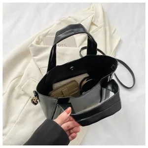 Casual black soft leather tote bucket bag detail showing spacious interior and handles.