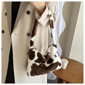 Detail view of stylish plush cow print underarm shoulder bag showcasing soft texture and trendy design.