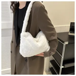 Detailed shot of a stylish white fluffy plush underarm shoulder bag worn by a model in a scene.