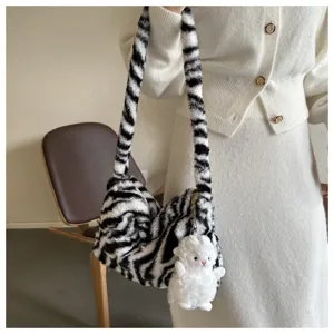 Fuzzy zebra pattern shoulder bag for women, stylish plush underarm bag with cute plush pendant.
